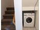 Laundry room featuring a modern washer, located adjacent to the staircase at 30273 Conifer Rd, Evergreen, CO 80439