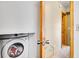 Convenient laundry room nook with a front load washer, storage, and easy access at 30273 Conifer Rd, Evergreen, CO 80439