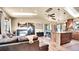 Open-concept living area with hardwood floors, modern fireplace, comfortable furniture, and lots of natural light at 30273 Conifer Rd, Evergreen, CO 80439