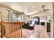 Cozy living room with hardwood floors, large windows, fireplace, and vaulted ceilings at 30273 Conifer Rd, Evergreen, CO 80439