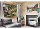 Cozy living room with fireplace, comfortable furniture, and picture window showcasing the outdoor greenery at 30273 Conifer Rd, Evergreen, CO 80439