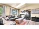 Spacious living room with hardwood floors, comfortable seating, fireplace, and plenty of natural light at 30273 Conifer Rd, Evergreen, CO 80439