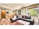 Inviting living room with hardwood floors, large windows, comfortable seating, and ample natural light at 30273 Conifer Rd, Evergreen, CO 80439