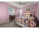 Charming bedroom with a metal-framed bed and colorful bedding at 9295 Dunraven Loop, Arvada, CO 80007