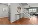 Inviting entryway with hardwood floors and circular mirror at 9295 Dunraven Loop, Arvada, CO 80007