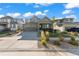 Two-story house with gray siding, landscaping, and a two-car garage at 9295 Dunraven Loop, Arvada, CO 80007