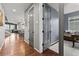 Hallway with hardwood floors, leading to an office and living area at 9295 Dunraven Loop, Arvada, CO 80007