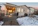 Back exterior view of house with deck and snowy yard at 9295 Dunraven Loop, Arvada, CO 80007