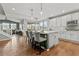 Modern kitchen with white cabinets, island, and hardwood floors at 9295 Dunraven Loop, Arvada, CO 80007