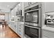 Bright kitchen featuring double ovens and white cabinetry at 9295 Dunraven Loop, Arvada, CO 80007