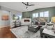 Spacious living room with corner fireplace and large windows at 9295 Dunraven Loop, Arvada, CO 80007