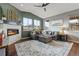 Spacious living room with corner fireplace and large windows at 9295 Dunraven Loop, Arvada, CO 80007