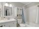 Bright bathroom with white vanity, cabinet, and updated fixtures and shower at 5873 S Prince St # 117C, Littleton, CO 80120
