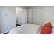 Bedroom featuring sliding door access, closet space, and neutral walls at 5873 S Prince St # 117C, Littleton, CO 80120