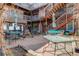 Courtyard area with blue tables and seating, surrounded by multi-level building at 5873 S Prince St # 117C, Littleton, CO 80120