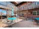Courtyard area with blue tables and seating, surrounded by multi-level building at 5873 S Prince St # 117C, Littleton, CO 80120