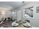 Bright dining area with a round table, modern chairs, and natural light from nearby windows at 5873 S Prince St # 117C, Littleton, CO 80120