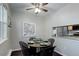 Cozy dining area with a round table, modern chairs, and bright lighting for a pleasant dining experience at 5873 S Prince St # 117C, Littleton, CO 80120