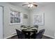 Bright dining area featuring a round table, stylish chairs, and natural light for a welcoming atmosphere at 5873 S Prince St # 117C, Littleton, CO 80120