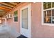 Exterior door view of unit 117 with pink exterior at 5873 S Prince St # 117C, Littleton, CO 80120