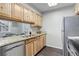 Well-lit kitchen with granite countertops, wood cabinets, and stainless steel appliances for modern living at 5873 S Prince St # 117C, Littleton, CO 80120