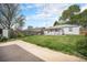 Expansive backyard with lush greenery, a detached garage, and a peaceful setting at 390 Yates St, Denver, CO 80219