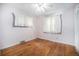 Cozy bedroom featuring hardwood floors, neutral walls, and natural light from two windows at 390 Yates St, Denver, CO 80219