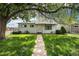 Quaint single-story home with walkway and a lawn shaded by a mature tree at 390 Yates St, Denver, CO 80219