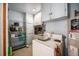Functional laundry room with shelving, storage cabinets, and a washing machine at 390 Yates St, Denver, CO 80219