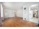 Open-concept living area leading to the kitchen, featuring hardwood floors at 390 Yates St, Denver, CO 80219