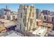 High-angle shot capturing the building's design, balconies, and rooftop amenities, set against the city backdrop at 300 W 11Th Ave # 8C, Denver, CO 80204