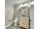 Cozy powder room with neutral tones, granite countertop, and updated fixtures at 300 W 11Th Ave # 8C, Denver, CO 80204