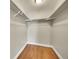 Empty closet space with hardwood flooring and metal rod for hanging at 300 W 11Th Ave # 8C, Denver, CO 80204