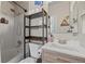 Updated bathroom featuring tiled shower, modern sink, and wood shelving at 5550 W 80Th Pl # 23, Arvada, CO 80003