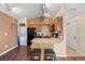 The kitchen boasts a breakfast bar, black appliances, and wood cabinets at 5550 W 80Th Pl # 23, Arvada, CO 80003