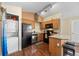 Compact kitchen offers wood cabinets, black appliances, and convenient laundry area at 5550 W 80Th Pl # 23, Arvada, CO 80003