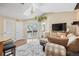 Cozy living room boasts a skylight, balcony access, and comfortable seating area at 5550 W 80Th Pl # 23, Arvada, CO 80003