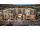 An eye-level view of a modern, mixed-use building with retail and residential apartments at 20 Wilcox St # 316, Castle Rock, CO 80104