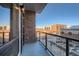 View from the balcony through the clear glass railings overlooking a cityscape at 20 Wilcox St # 316, Castle Rock, CO 80104