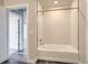Bathroom featuring a white tub and shower combination with modern tiled walls at 20 Wilcox St # 316, Castle Rock, CO 80104