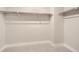 Bright closet with shelving for ample storage in a neutral palette with gray carpeting at 20 Wilcox St # 316, Castle Rock, CO 80104