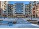 Modern apartment complex showcasing brick and stone accents, complemented by a landscaped entrance at 20 Wilcox St # 316, Castle Rock, CO 80104