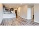 Open-concept living space with hardwood floors, connecting to a kitchen with stainless steel appliances at 20 Wilcox St # 316, Castle Rock, CO 80104