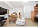 Spacious basement recreation room with fireplace and built-in shelving at 402 Garfield St, Denver, CO 80206