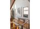 Bright hallway with hardwood floors, artwork, and modern metal railing at 402 Garfield St, Denver, CO 80206