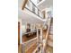 Modern staircase with metal railings overlooking a dining area and fireplace at 402 Garfield St, Denver, CO 80206