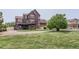 Expansive backyard with a multi-level deck, perfect for outdoor entertaining and enjoying the serene surroundings at 12745 Uinta St, Brighton, CO 80602