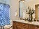 Bathroom featuring a double sink vanity with framed mirrors, a toilet, and a bathtub with shower at 12745 Uinta St, Brighton, CO 80602