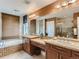 Bright bathroom with a double sink vanity, large mirror, soaking tub, and tiled shower space at 12745 Uinta St, Brighton, CO 80602
