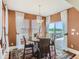 Cozy dining area with chandelier, stylish rug, and sliding glass doors to the outside deck area at 12745 Uinta St, Brighton, CO 80602